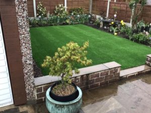 small terrace garden covered with artificial grass