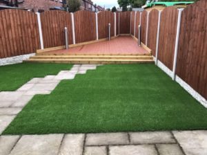Artificial lawn leading up to decking in Leeds