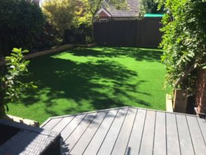 Shady garden with decking and brand new artificial lawn