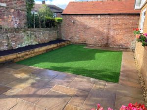 30sqm of artificial grass surrounded by paitio stones