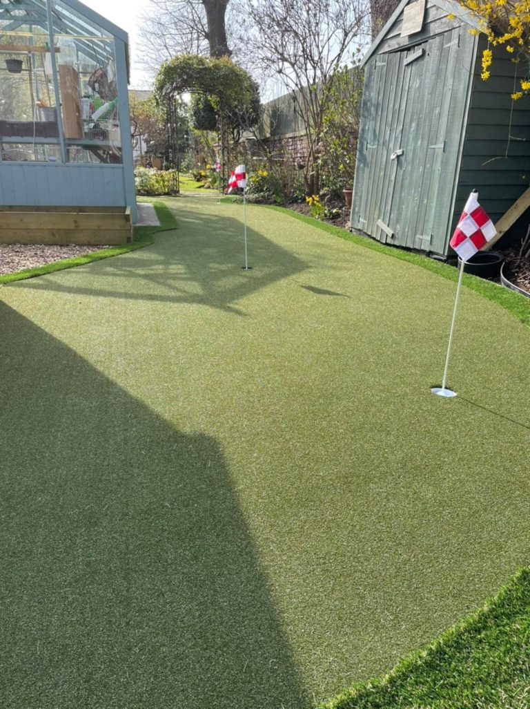putting green with greenhouse in centre