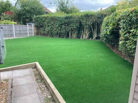 artificial lawn with hedges on right