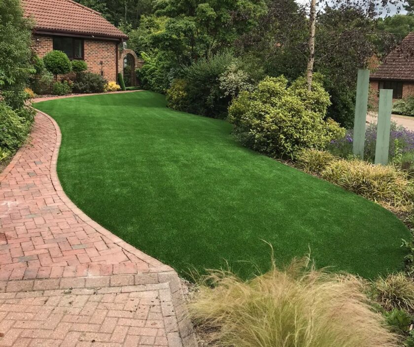 Curved lawn with red brick pathway
