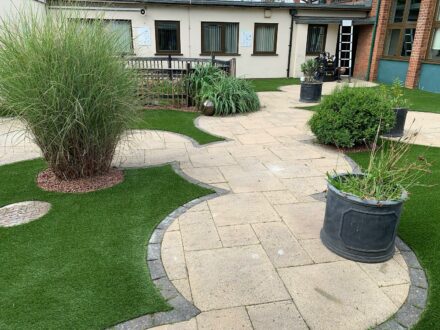 circular patios with artificial grass surroundings
