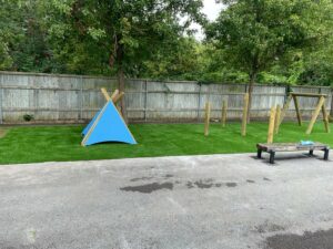play area with wooden tepee